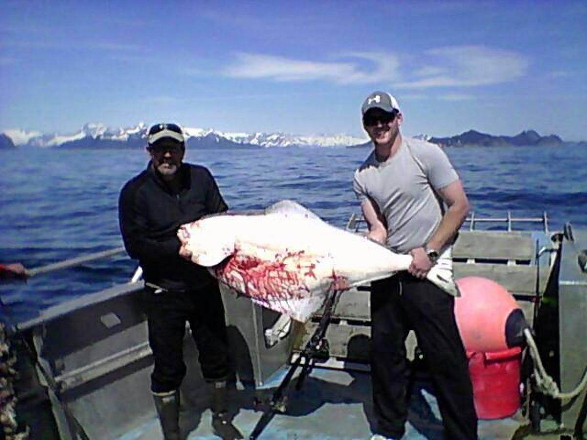 Capt Bill with a guest and his Halibut