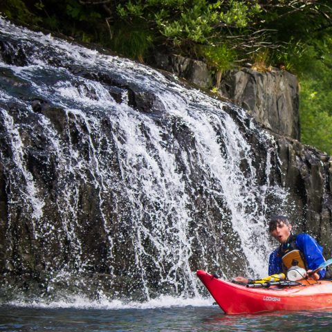 Kayaking through a waterfall, Seward, AK