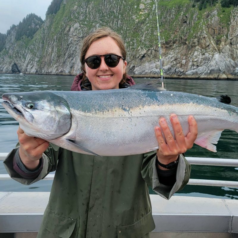abby holding a fish in the water