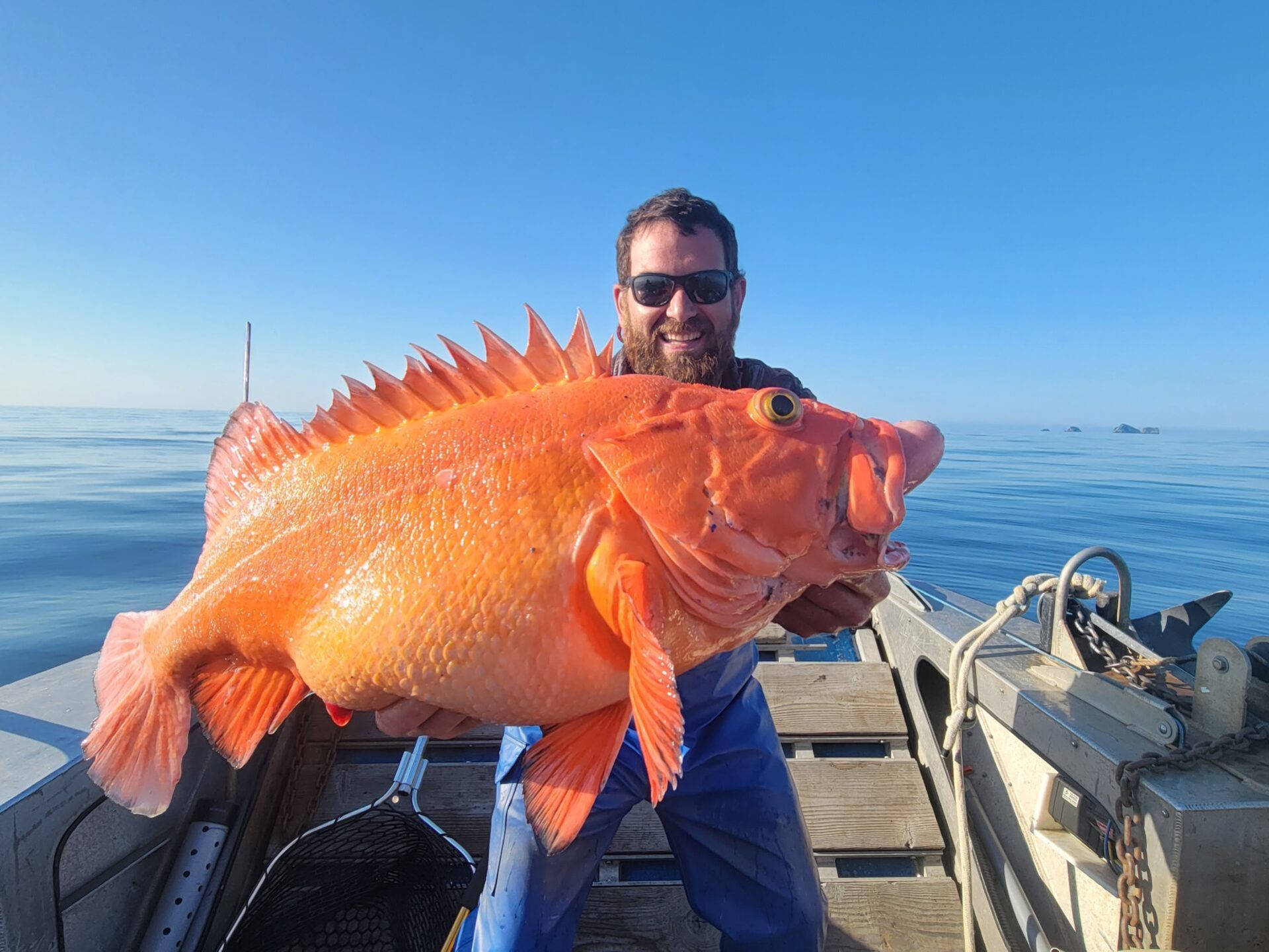 a man standing next to a body of water