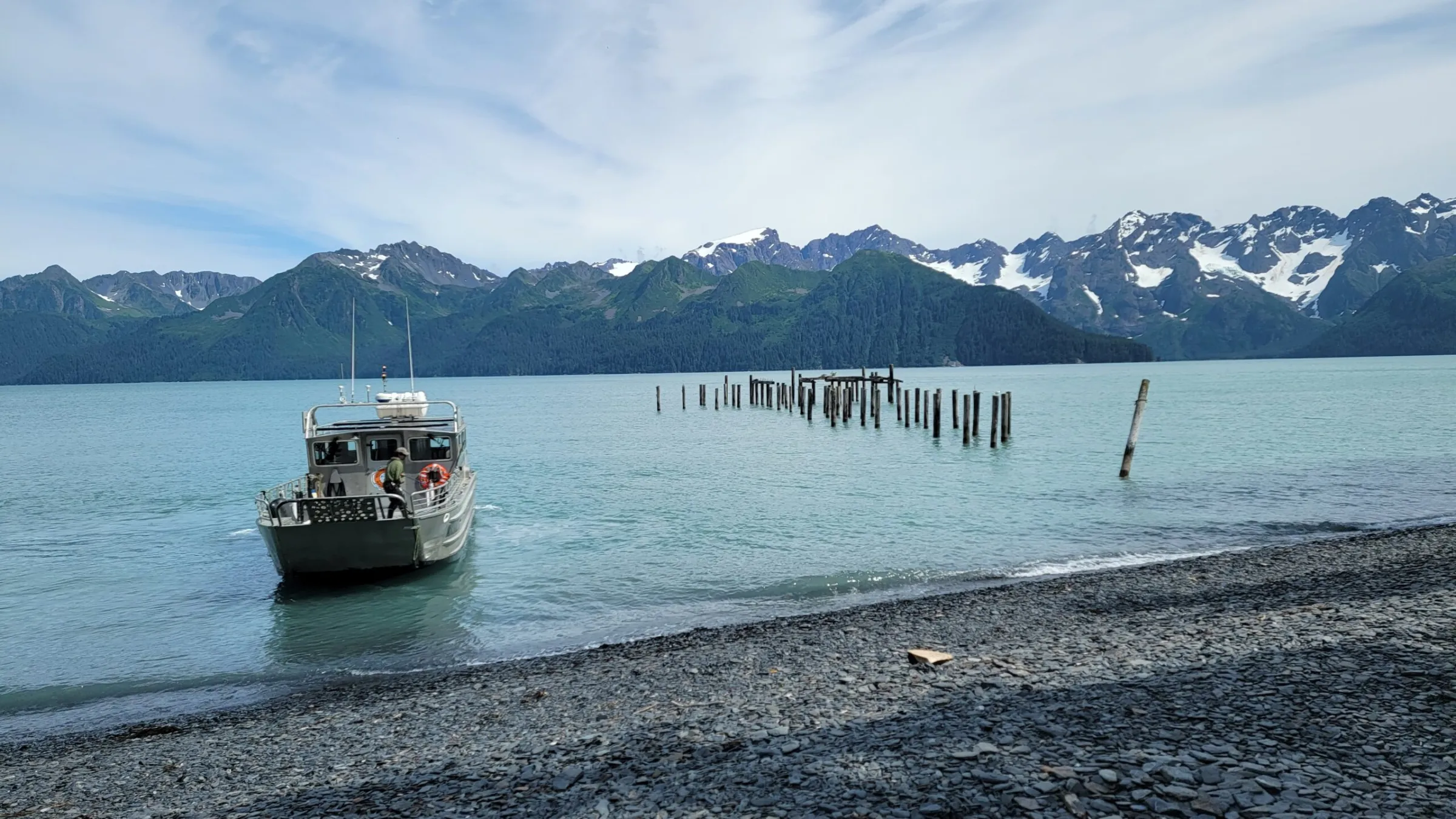 a boat on a body of water with a mountain in the background