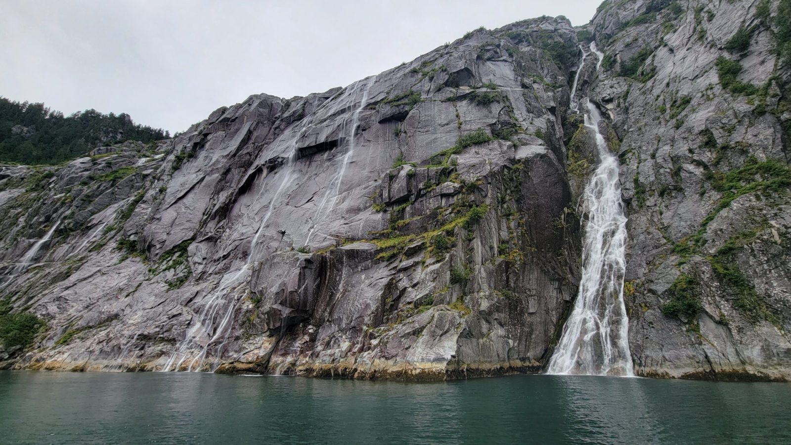 a large waterfall over some water
