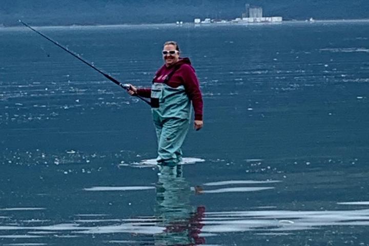 a women in the water fishing