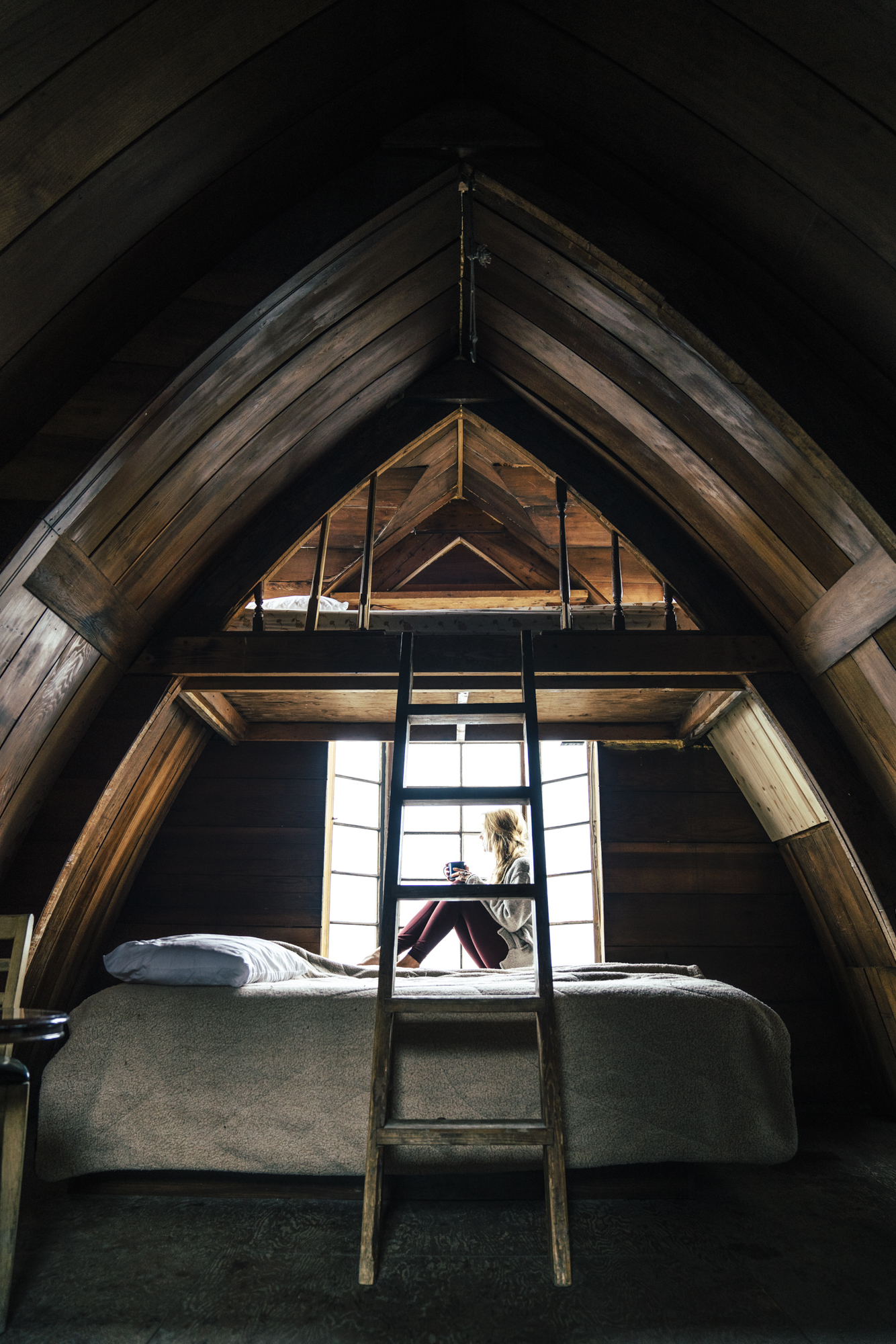 Girl in window of seaside cabin