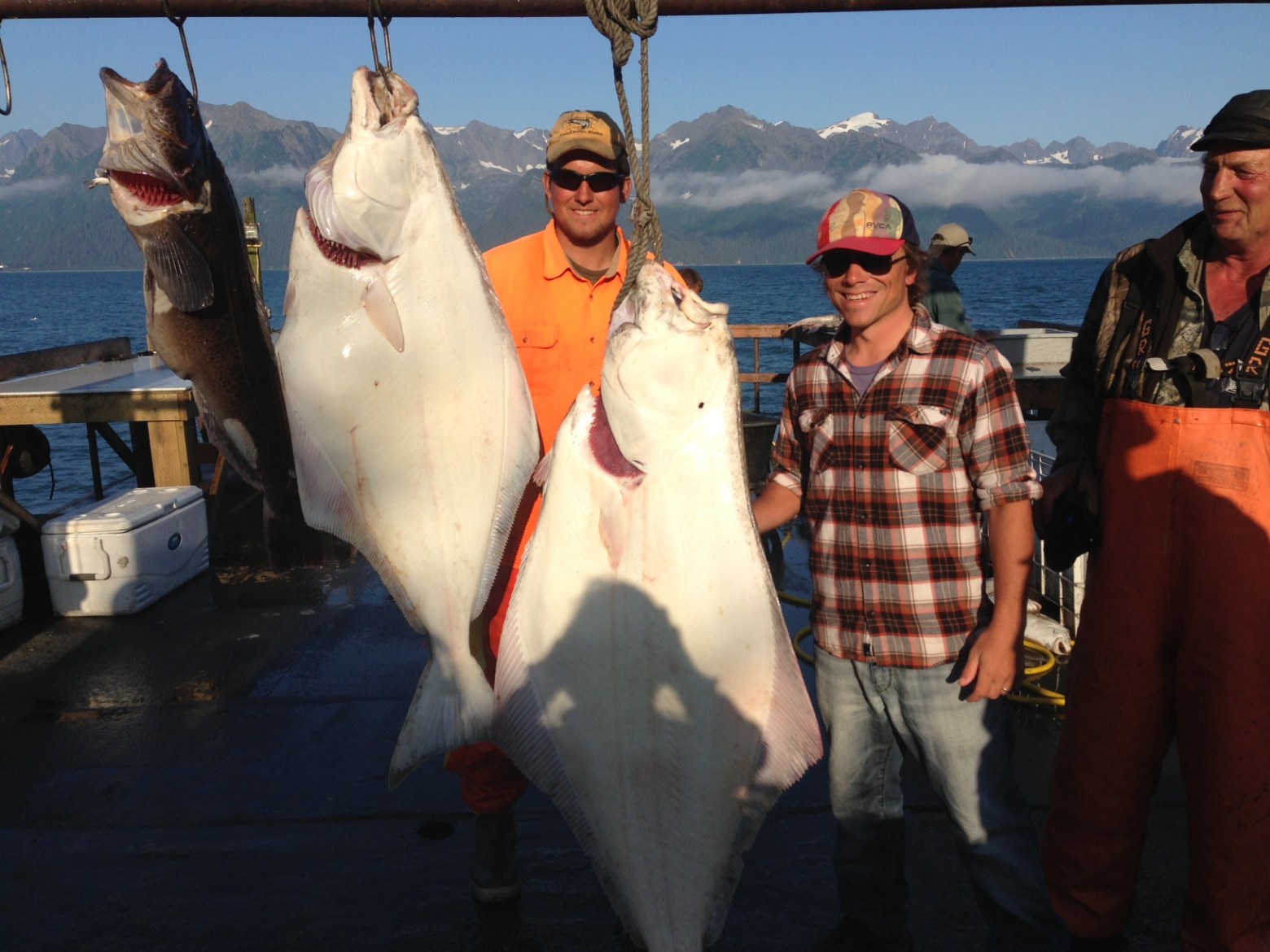 a group of people standing next to a person holding a fish