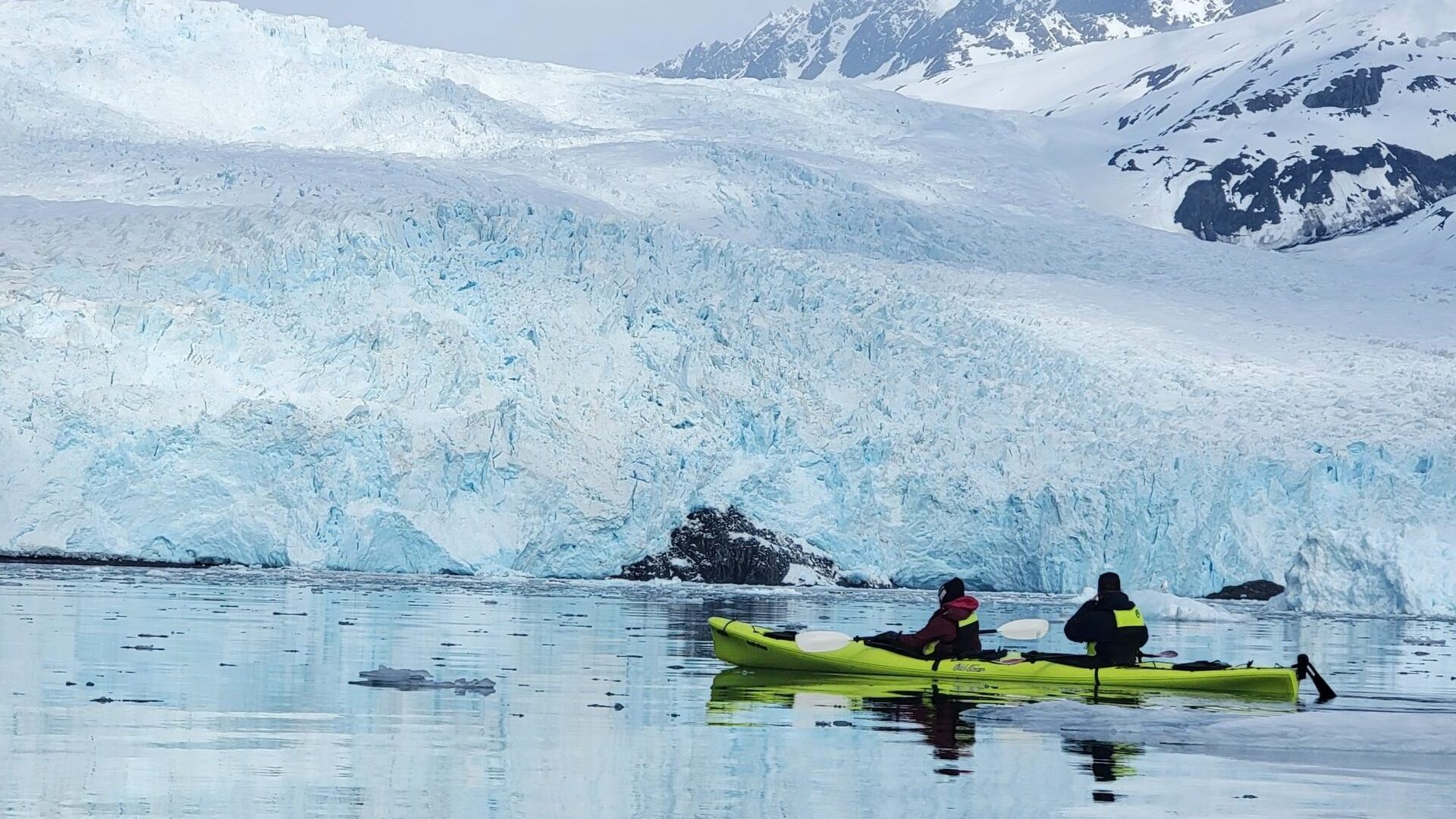 a group of people riding skis on a body of water
