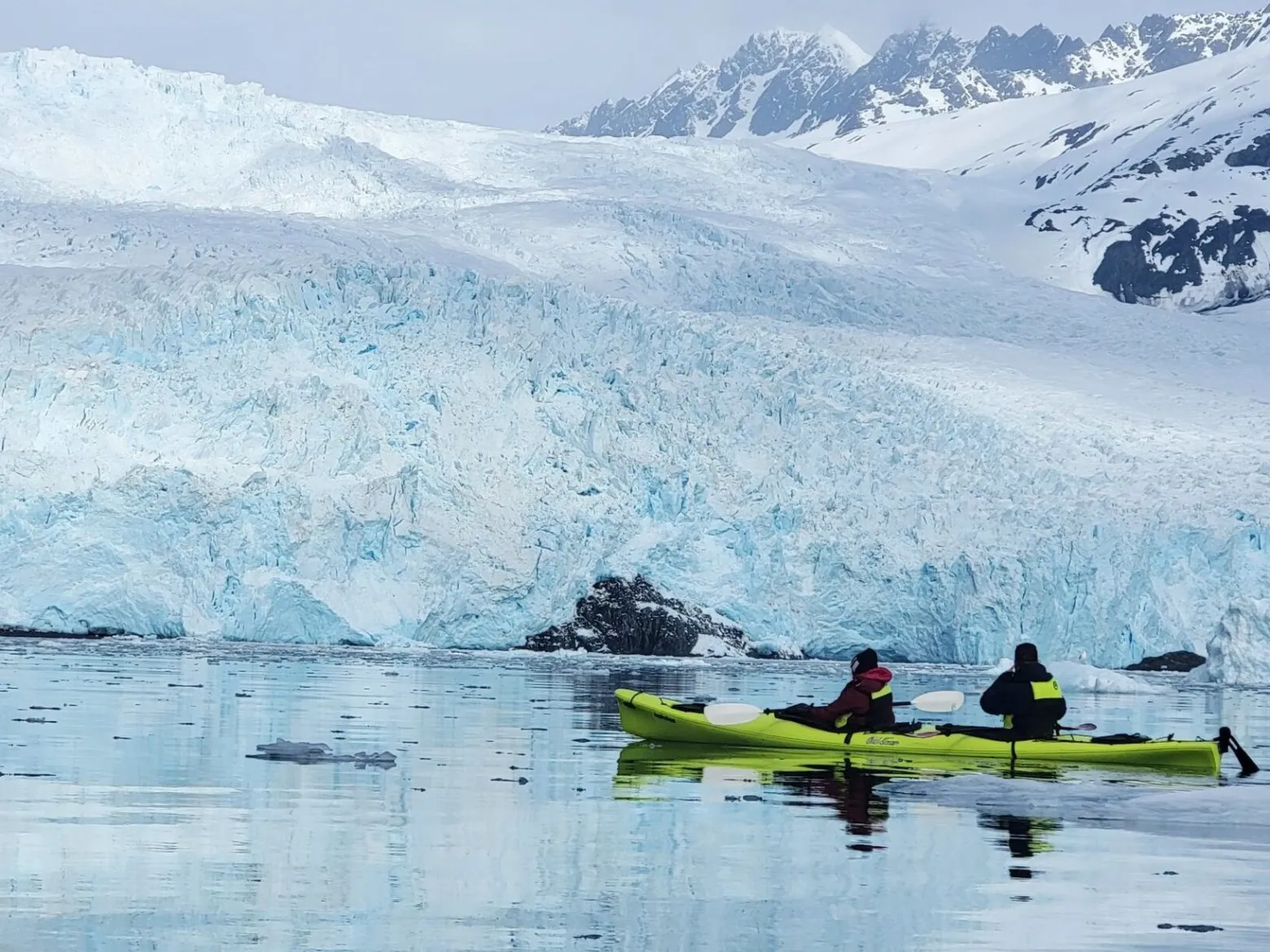 a group of people riding skis on a body of water