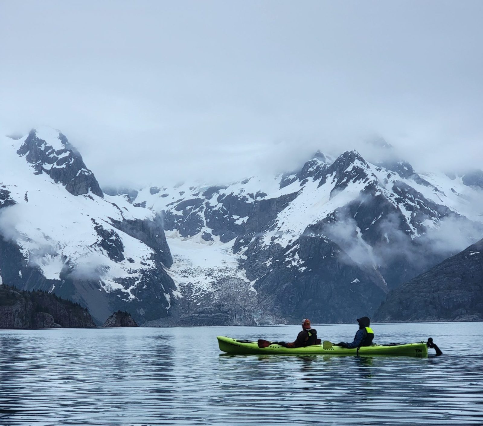 a group of people riding skis on a body of water