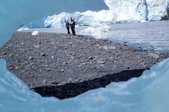 a man riding a surfboard on top of a snow covered mountain