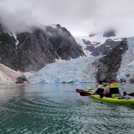 a group of people riding skis on a snowy mountain