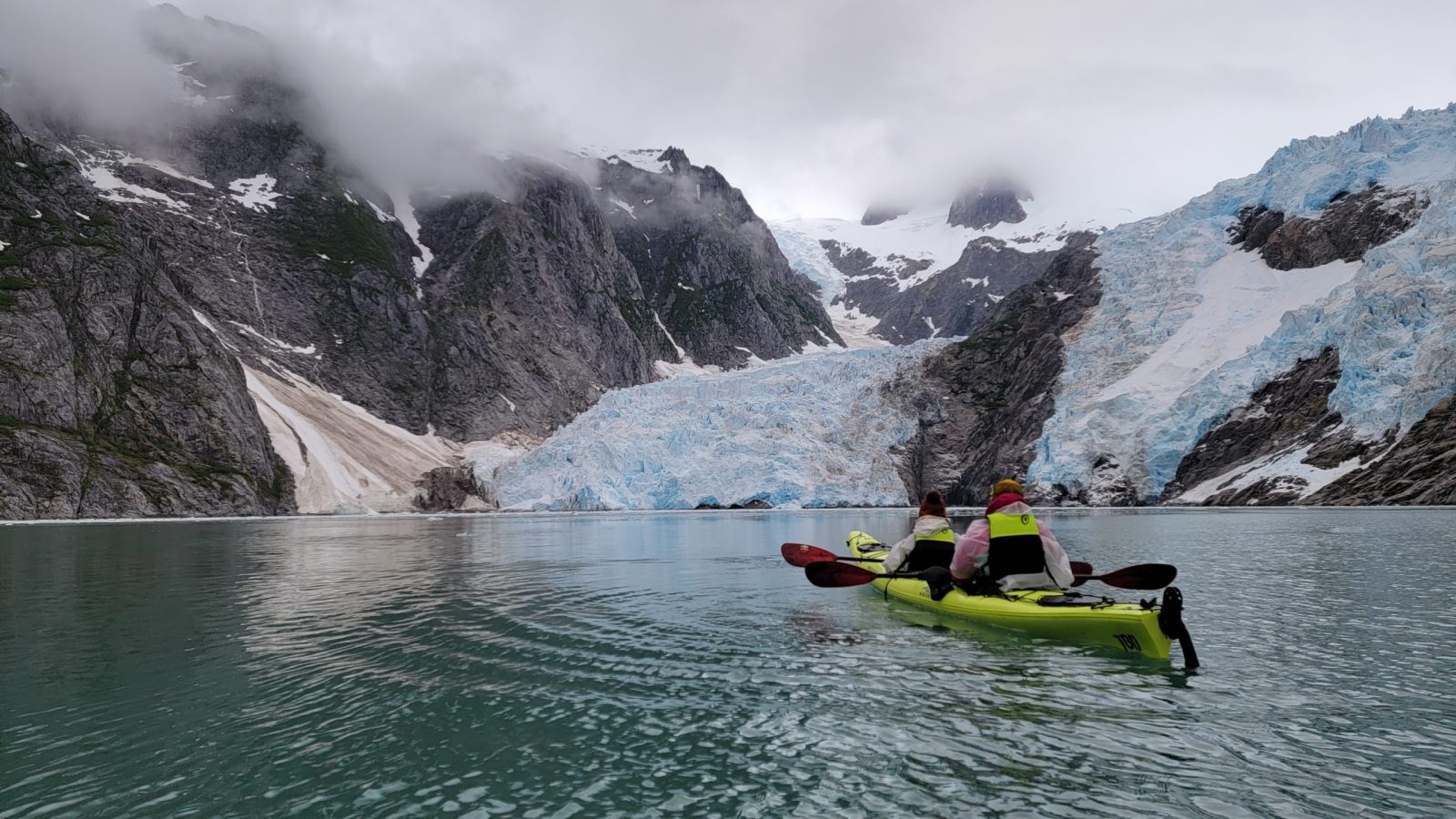 a group of people riding skis on a snowy mountain