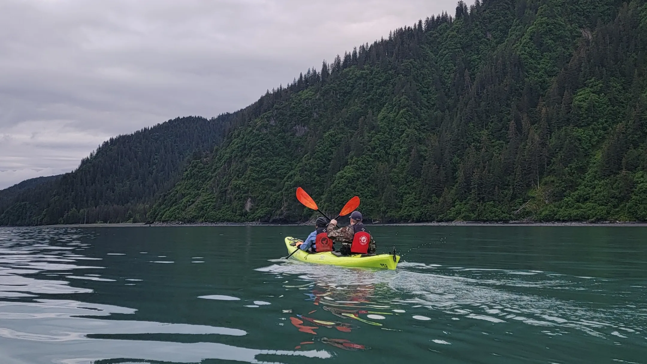 a man riding on the back of a boat in a body of water
