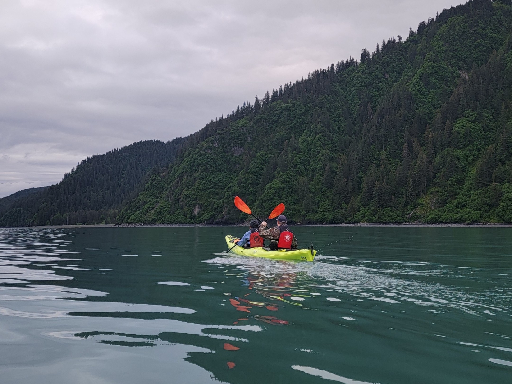 a man riding on the back of a boat in a body of water