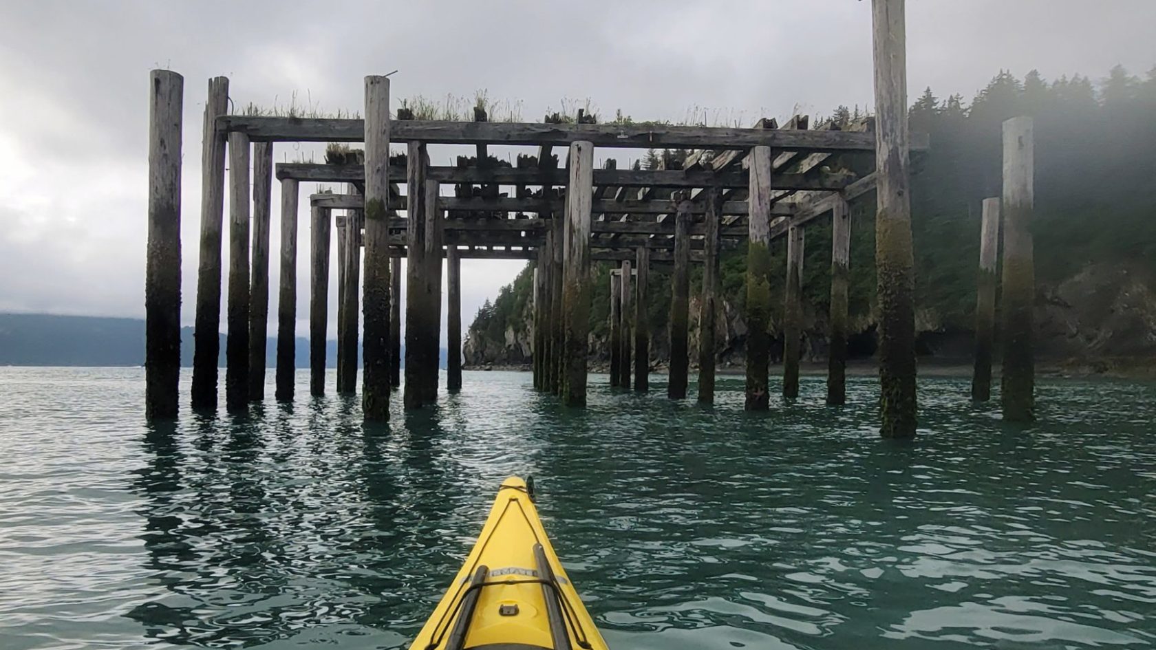 a boat sitting on top of a pier next to a body of water