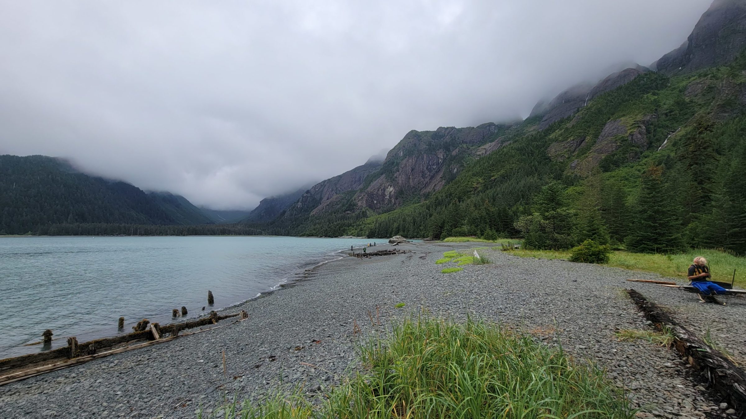 a group of people standing next to a body of water