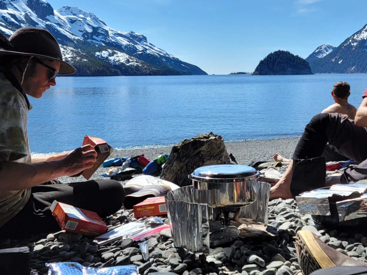 a person sitting on a rock near the ocean