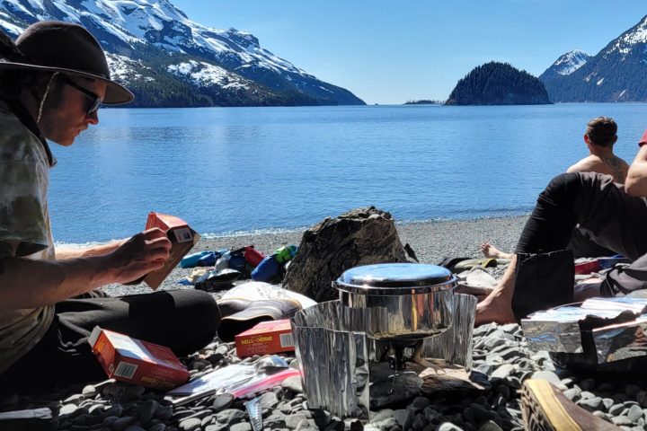 a person sitting on a rock near the ocean