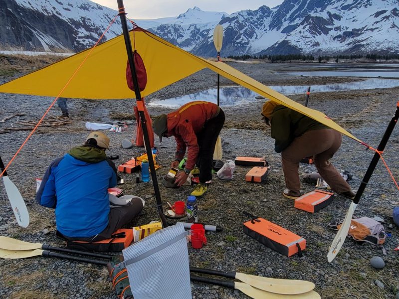 a group of people sitting in a tent