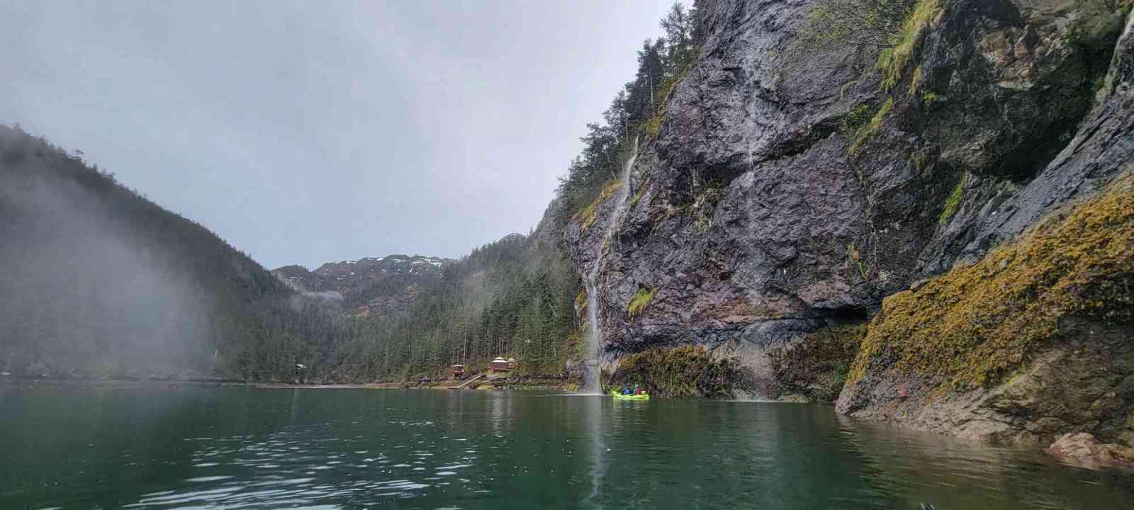 a body of water with a mountain in the background