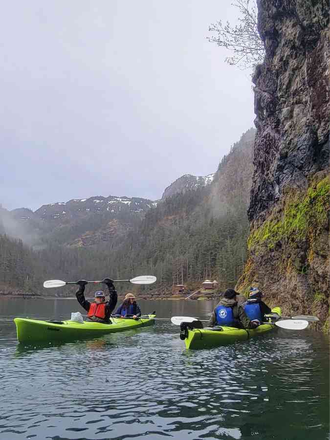 a group of people in a small boat in a body of water