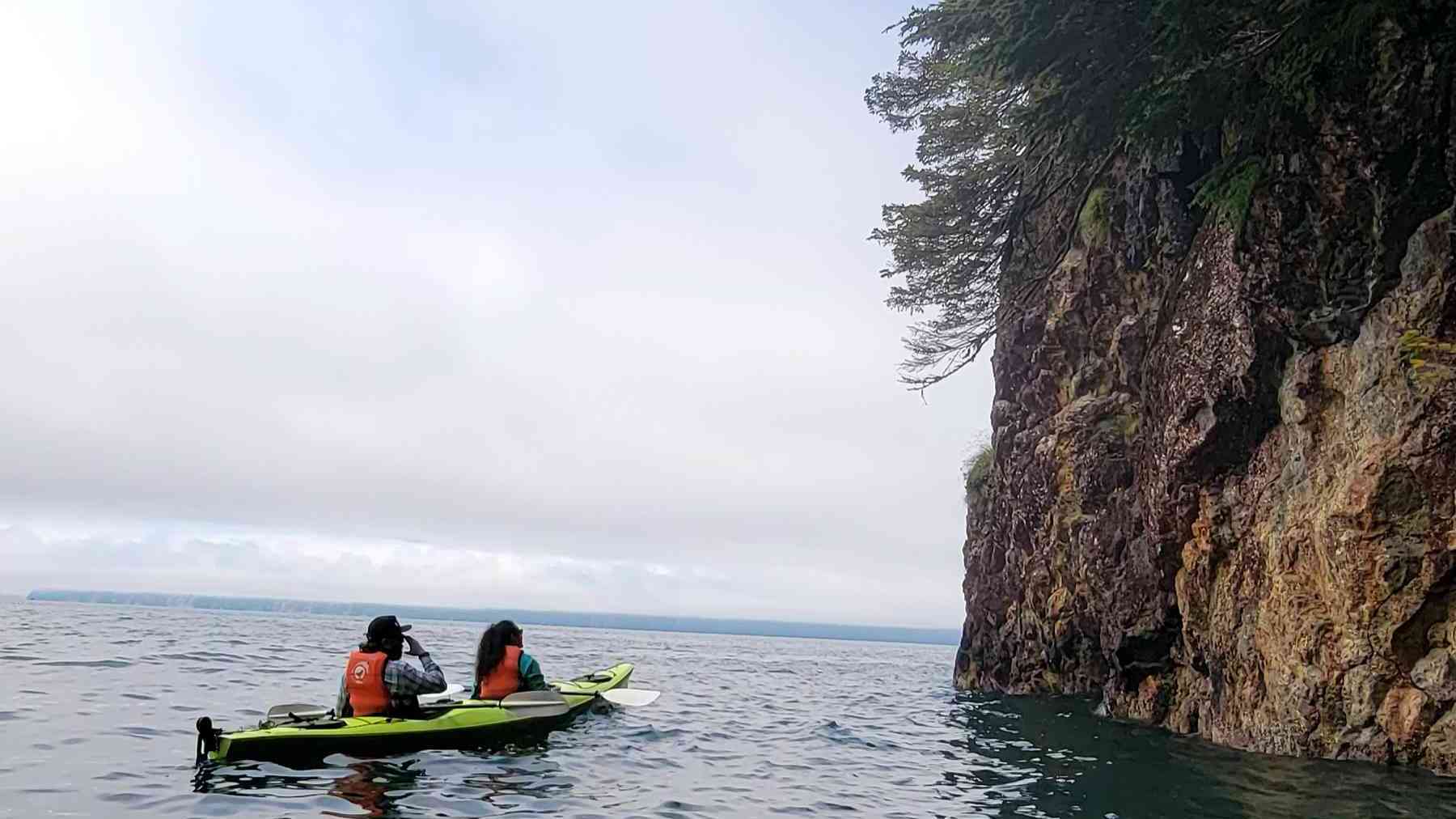 a person riding on the back of a boat in the water