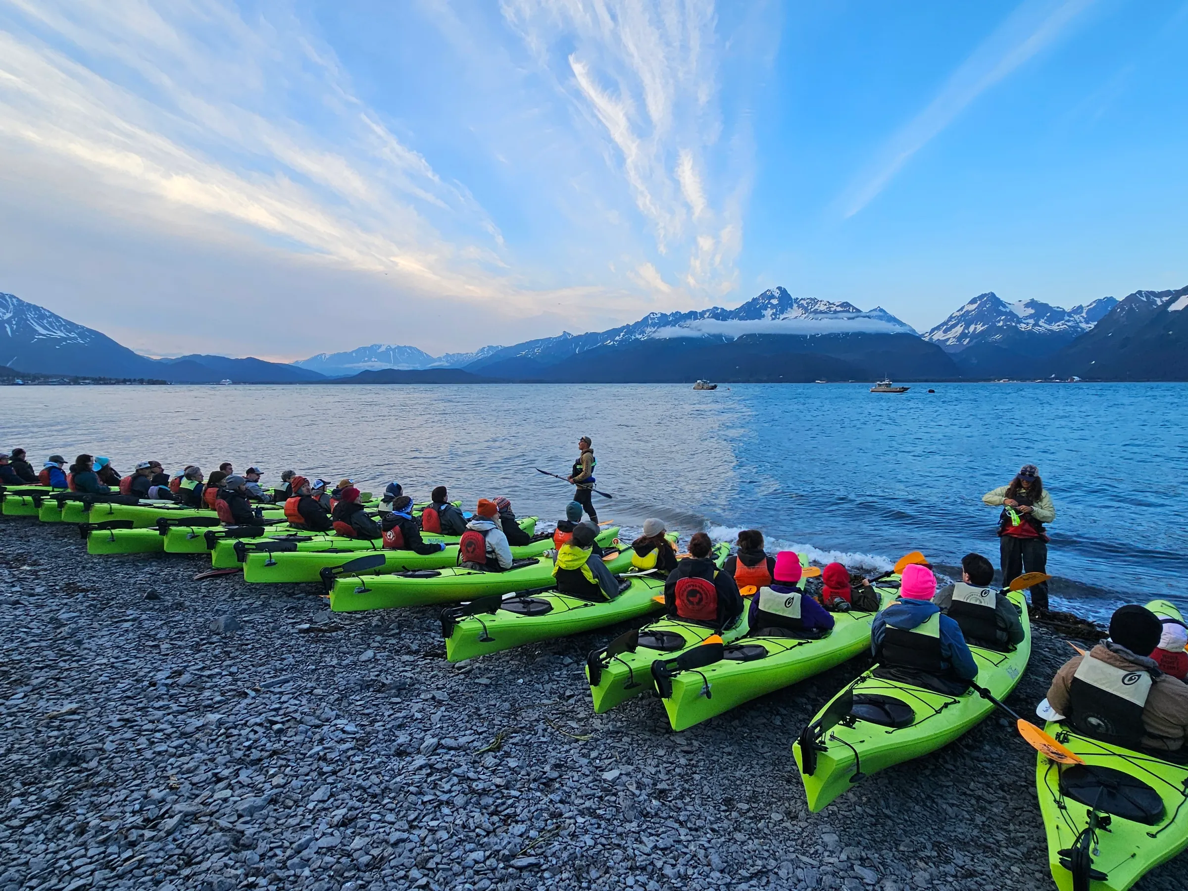a group of people in a boat on a body of water