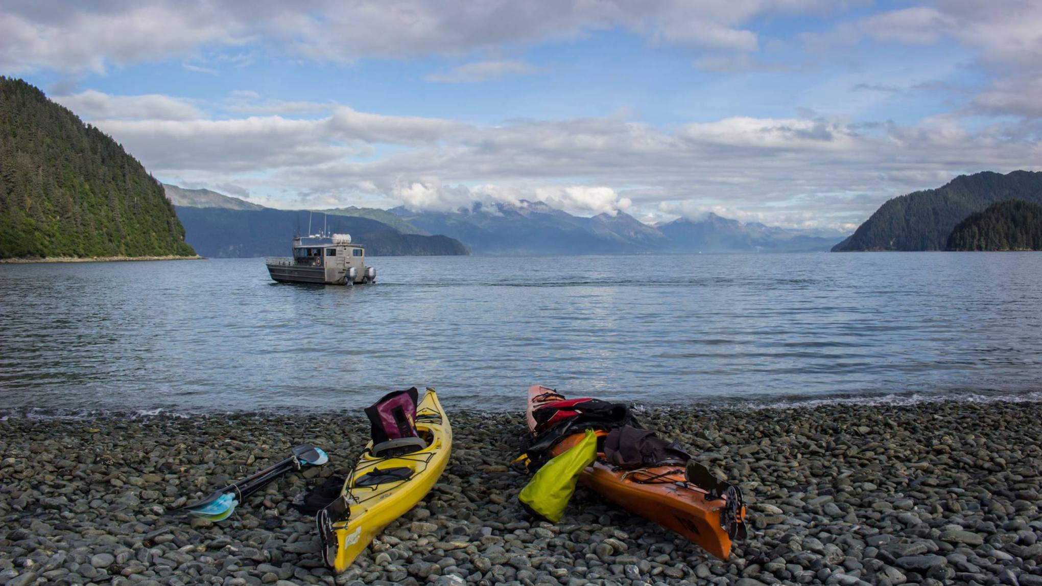 a rocky beach next to a body of water