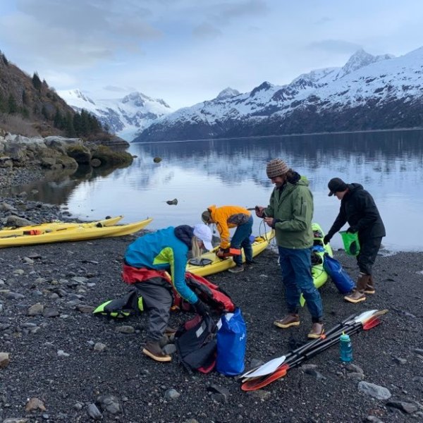 a group of people riding skis on a snowy mountain