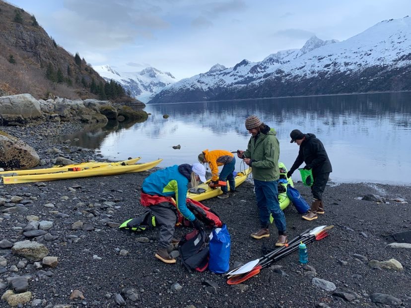 a group of people riding skis on a snowy mountain