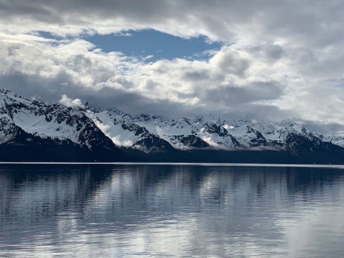 a body of water with a mountain in the background