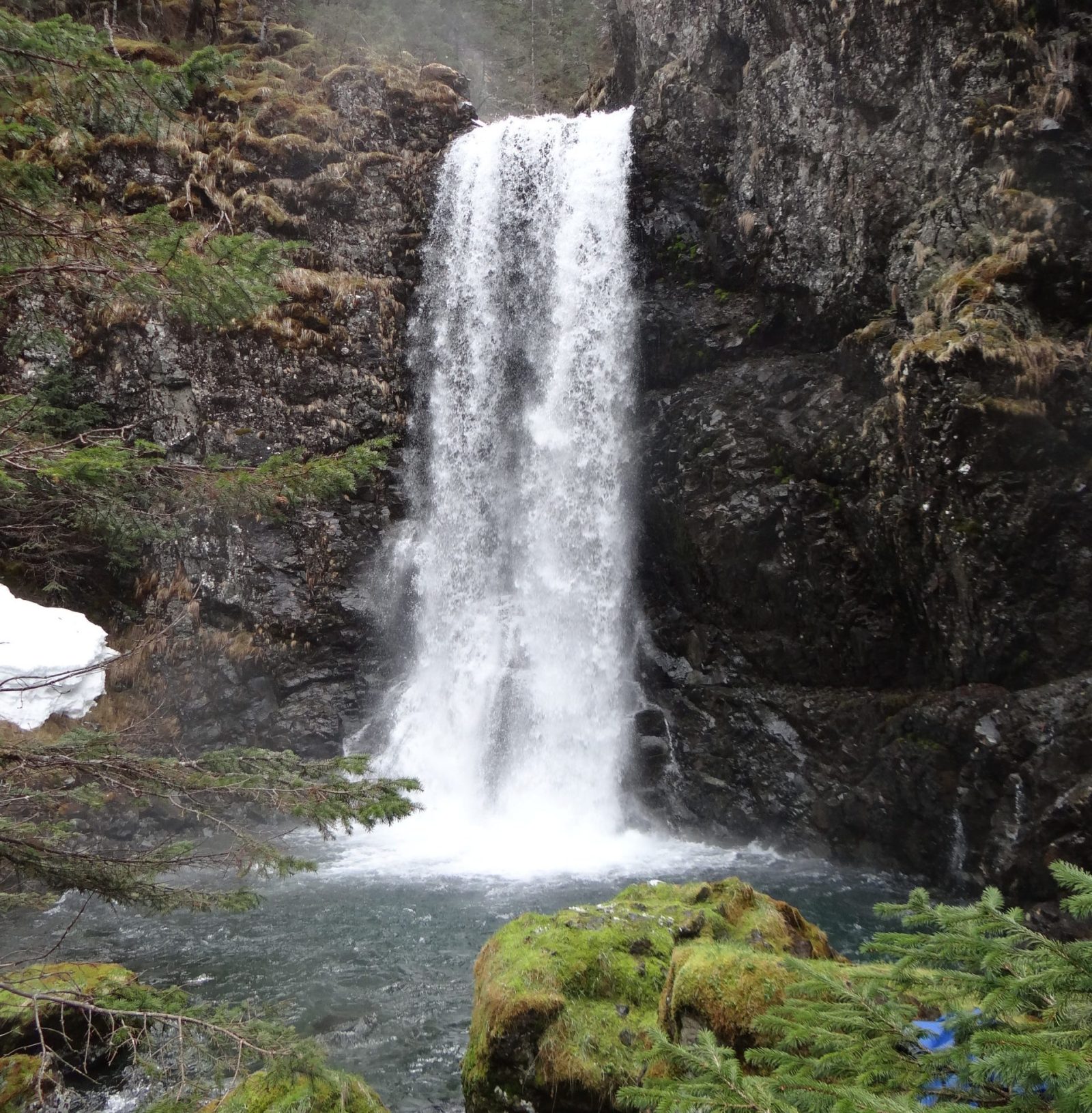 a large waterfall over some water