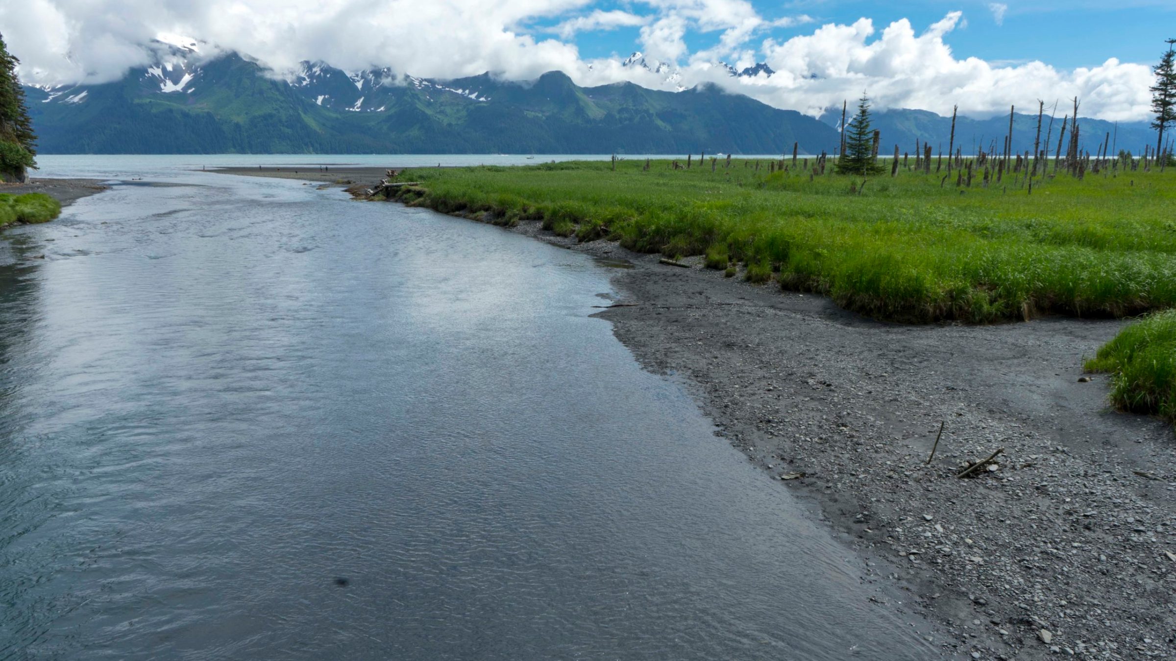 a narrow road next to a body of water