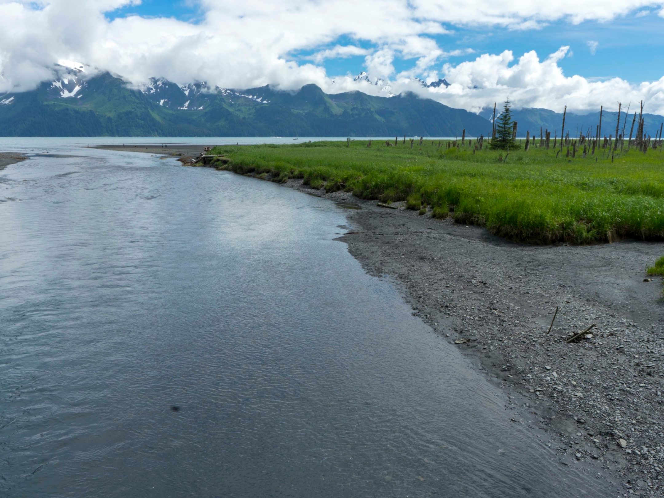 a narrow road next to a body of water