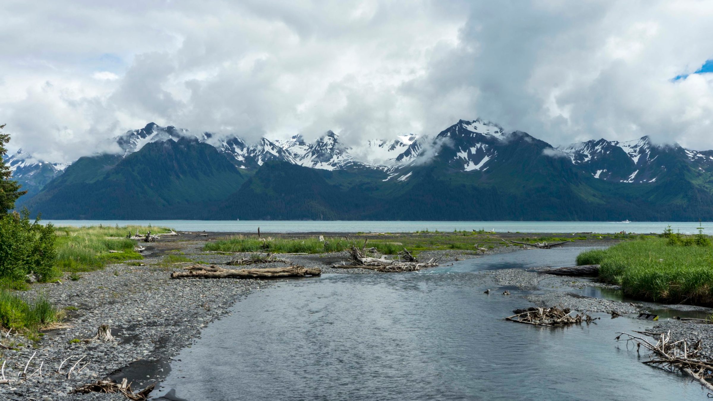 a body of water with a mountain in the background