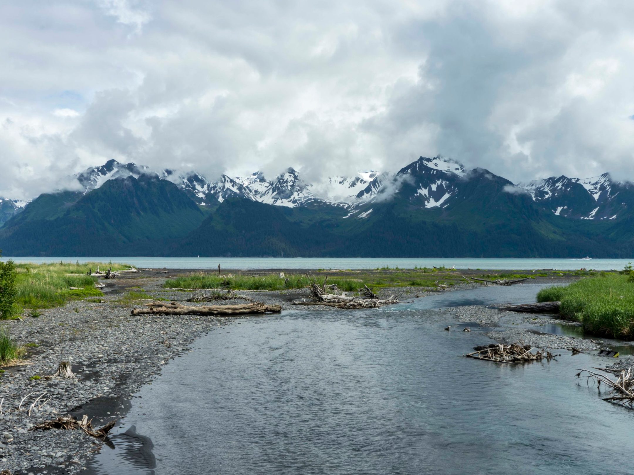 a body of water with a mountain in the background