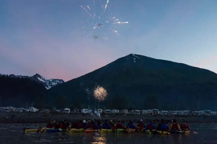 a group of people on a mountain lake