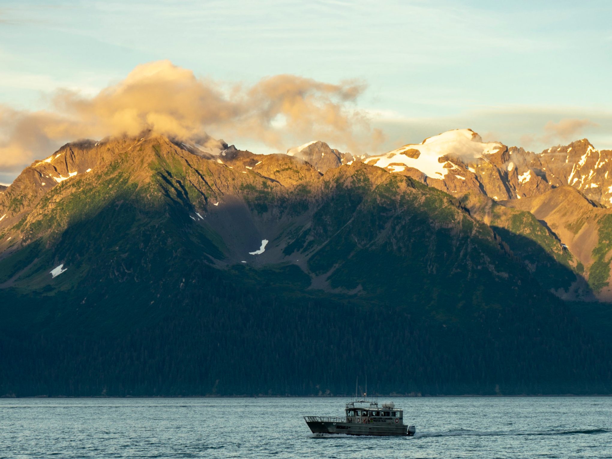 a body of water with a mountain in the background