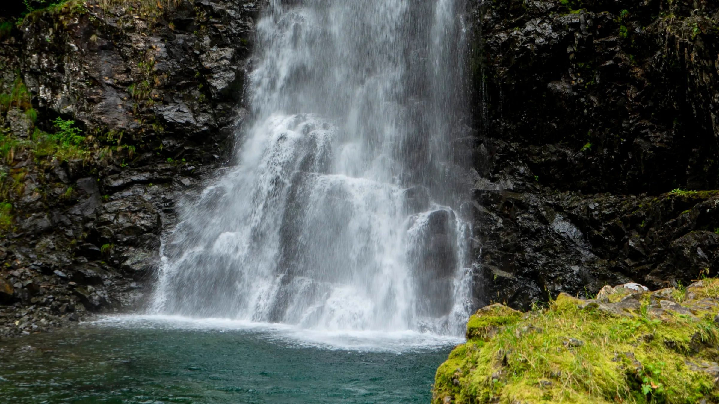 a large waterfall over some water