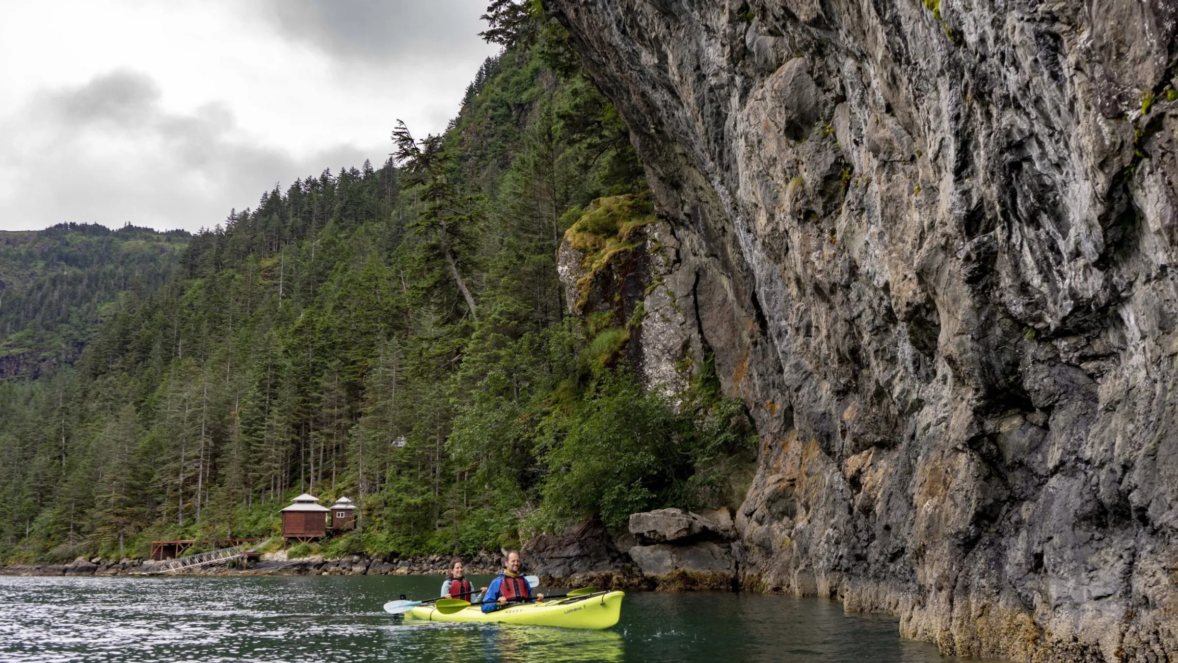 a small boat in a river next to a body of water
