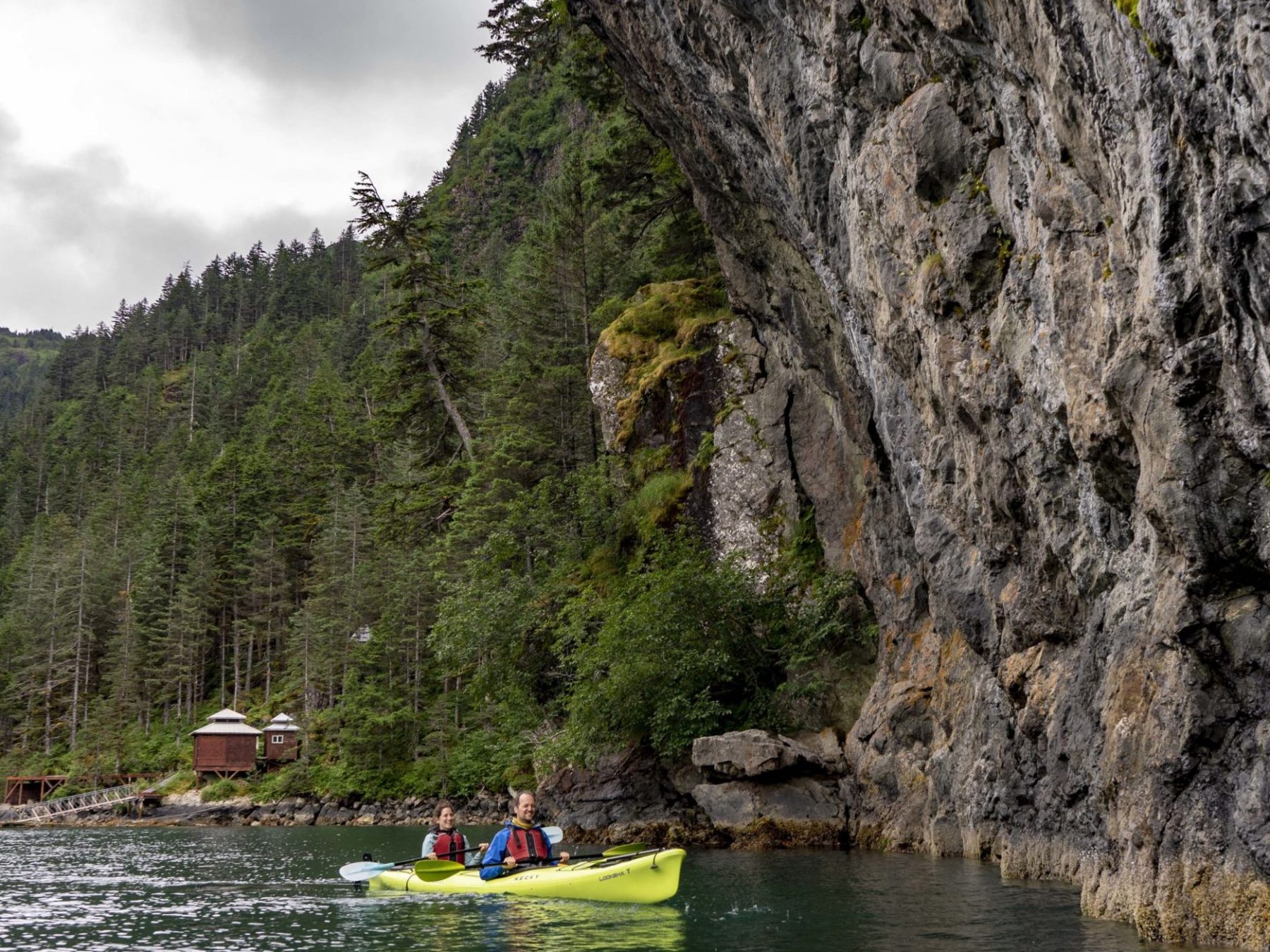 a small boat in a river next to a body of water