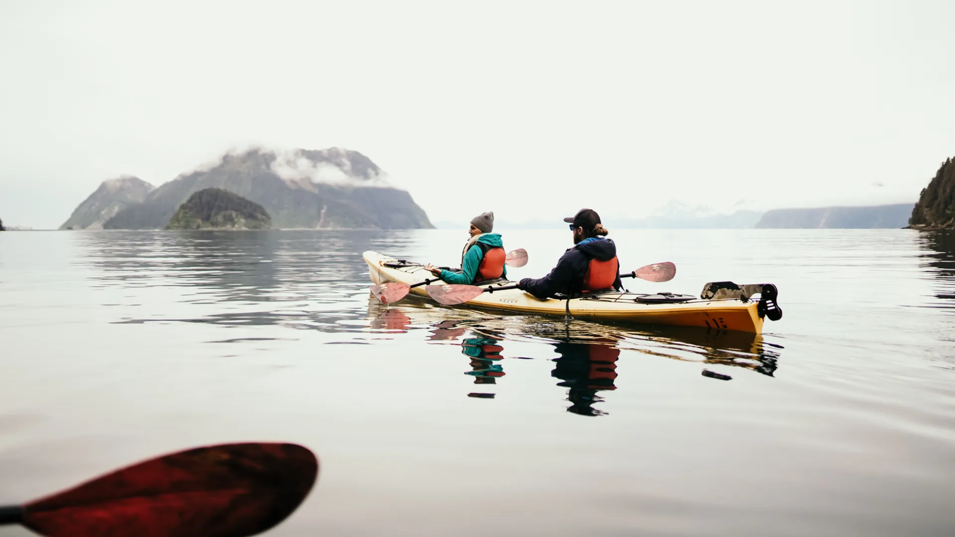 a group of people in a small boat in a body of water