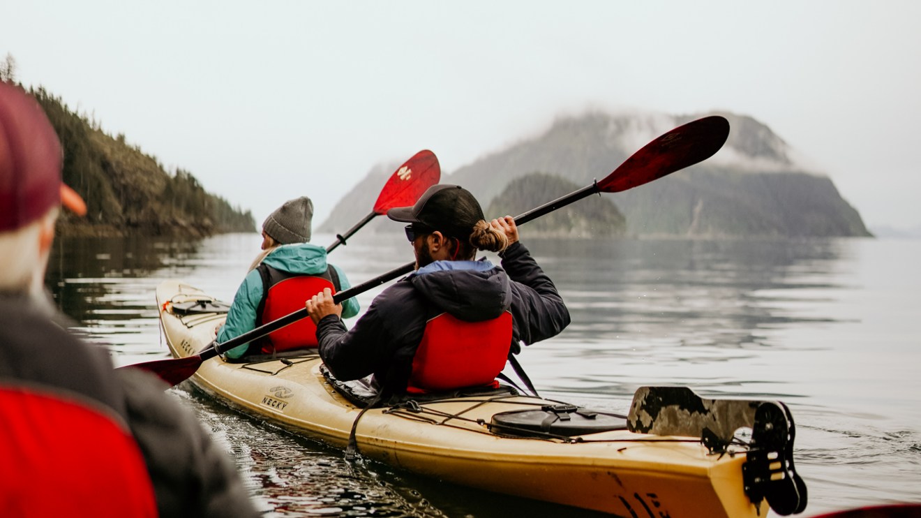 a man sitting in a kayak on a body of water Millers Landing Seward Alaska Beach Seaside