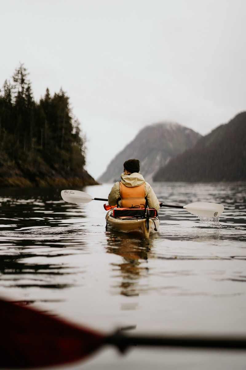 a person riding on the back of a boat in the water