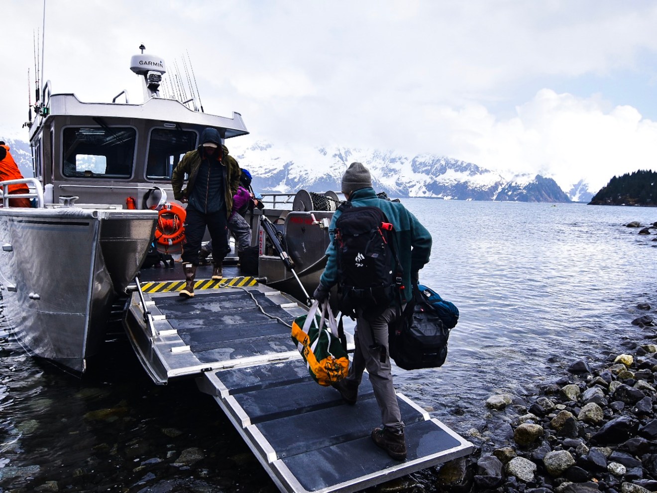 a group of people in a boat on a body of water