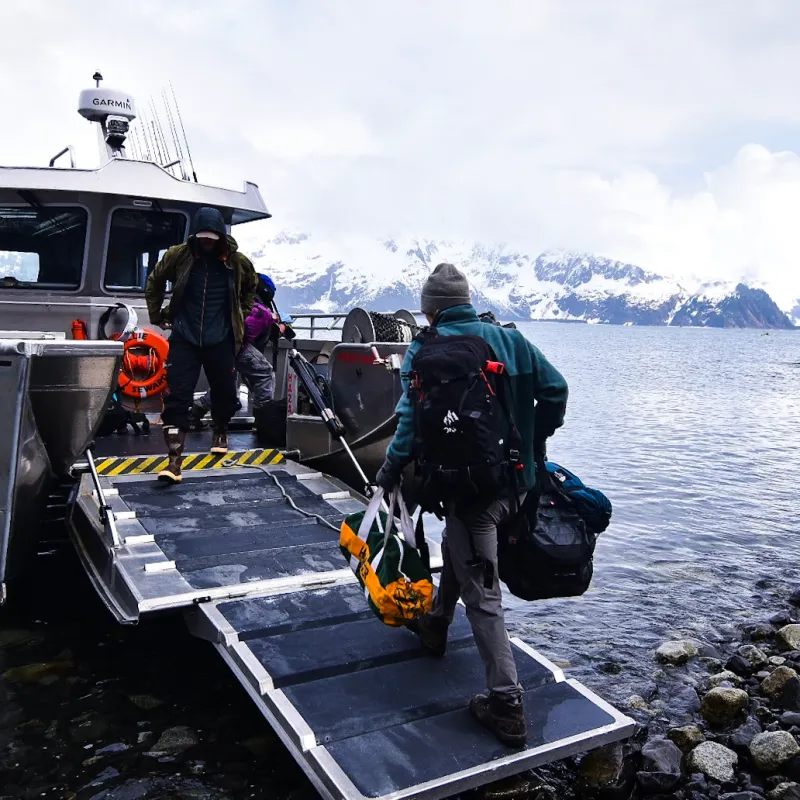 a group of people in a boat on a body of water