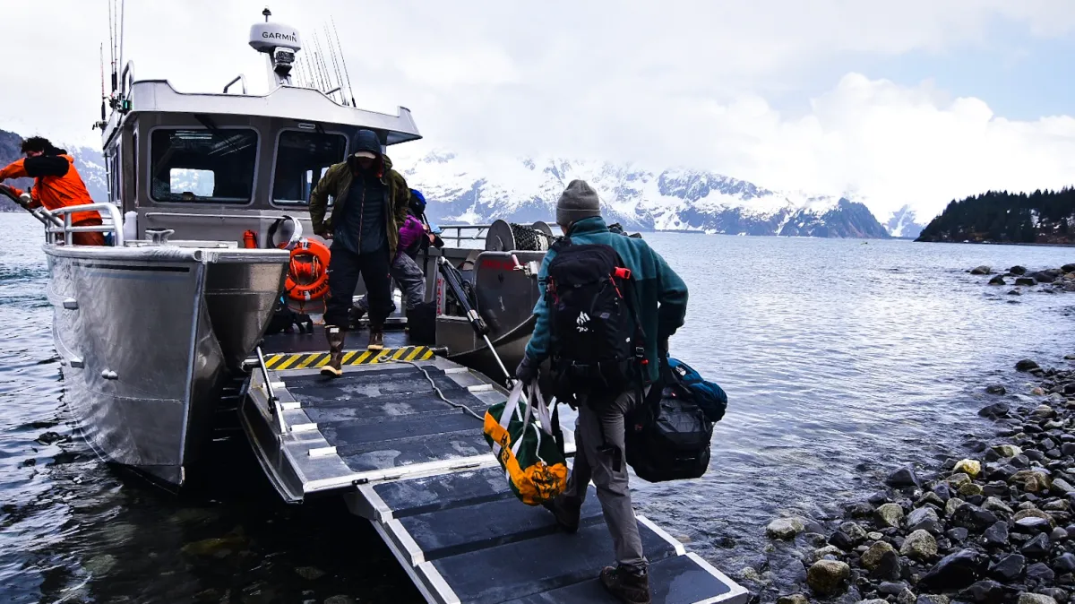 a group of people in a boat on a body of water