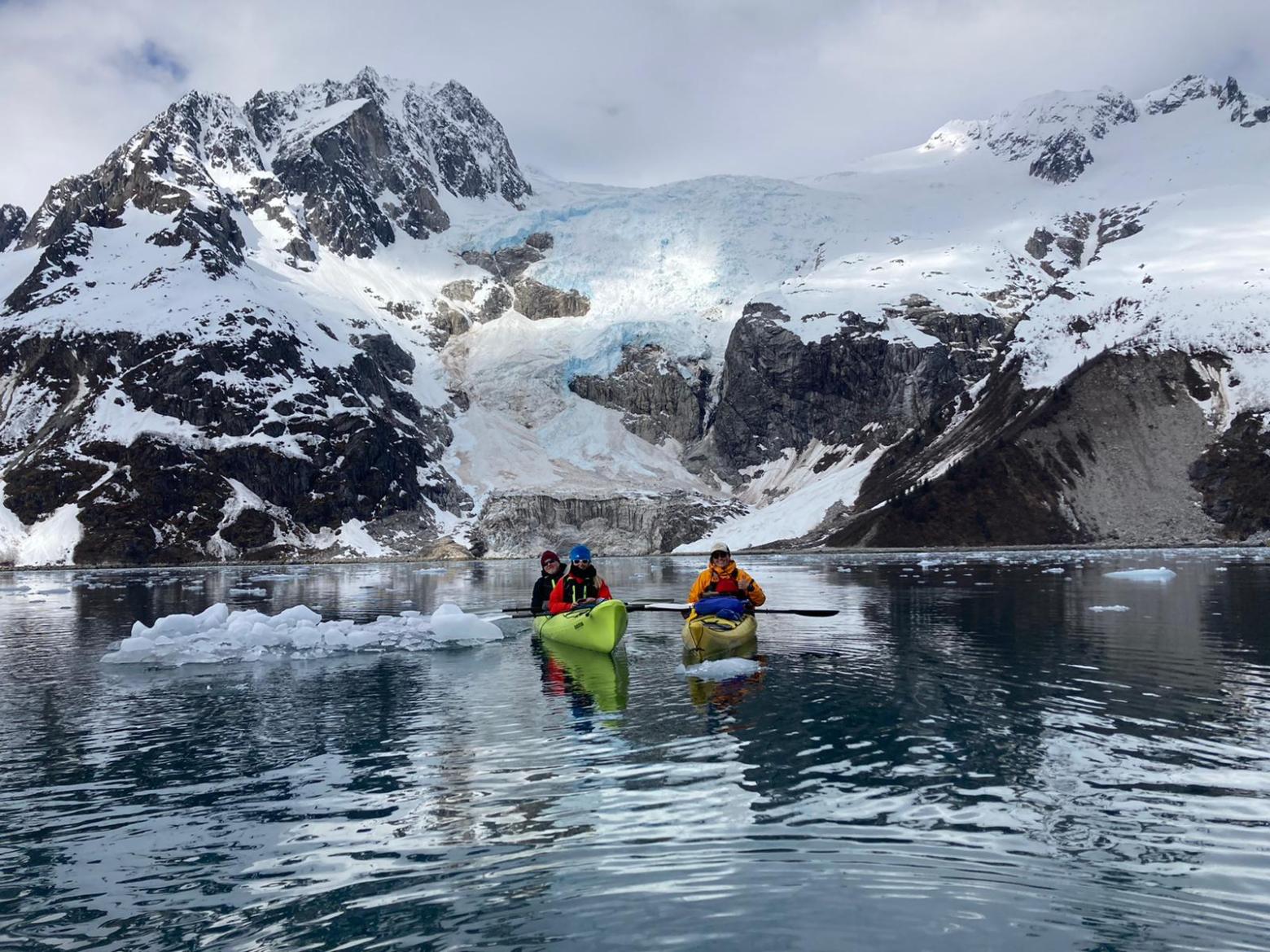 a group of people riding skis on a snowy mountain