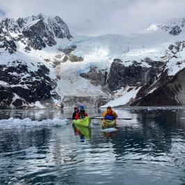 a group of people riding skis on a snowy mountain