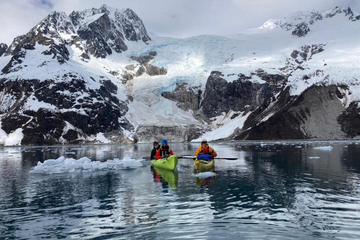 a group of people riding skis on a snowy mountain