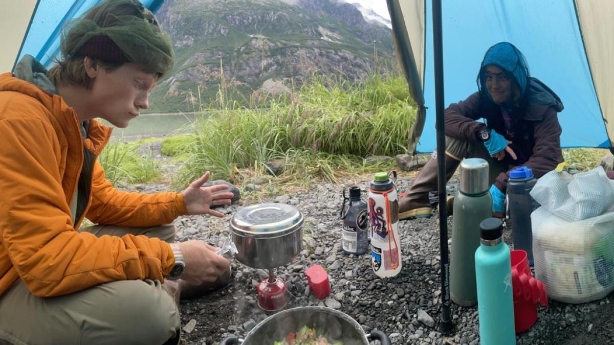 a man and a woman sitting at a table with food